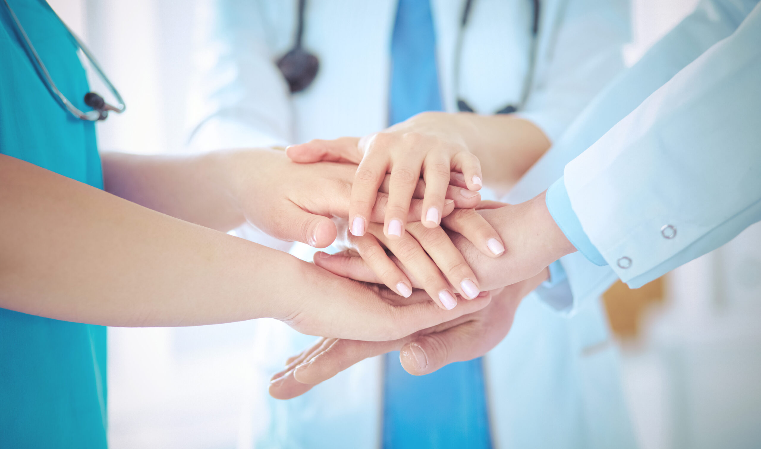 Group of doctors putting their hands together