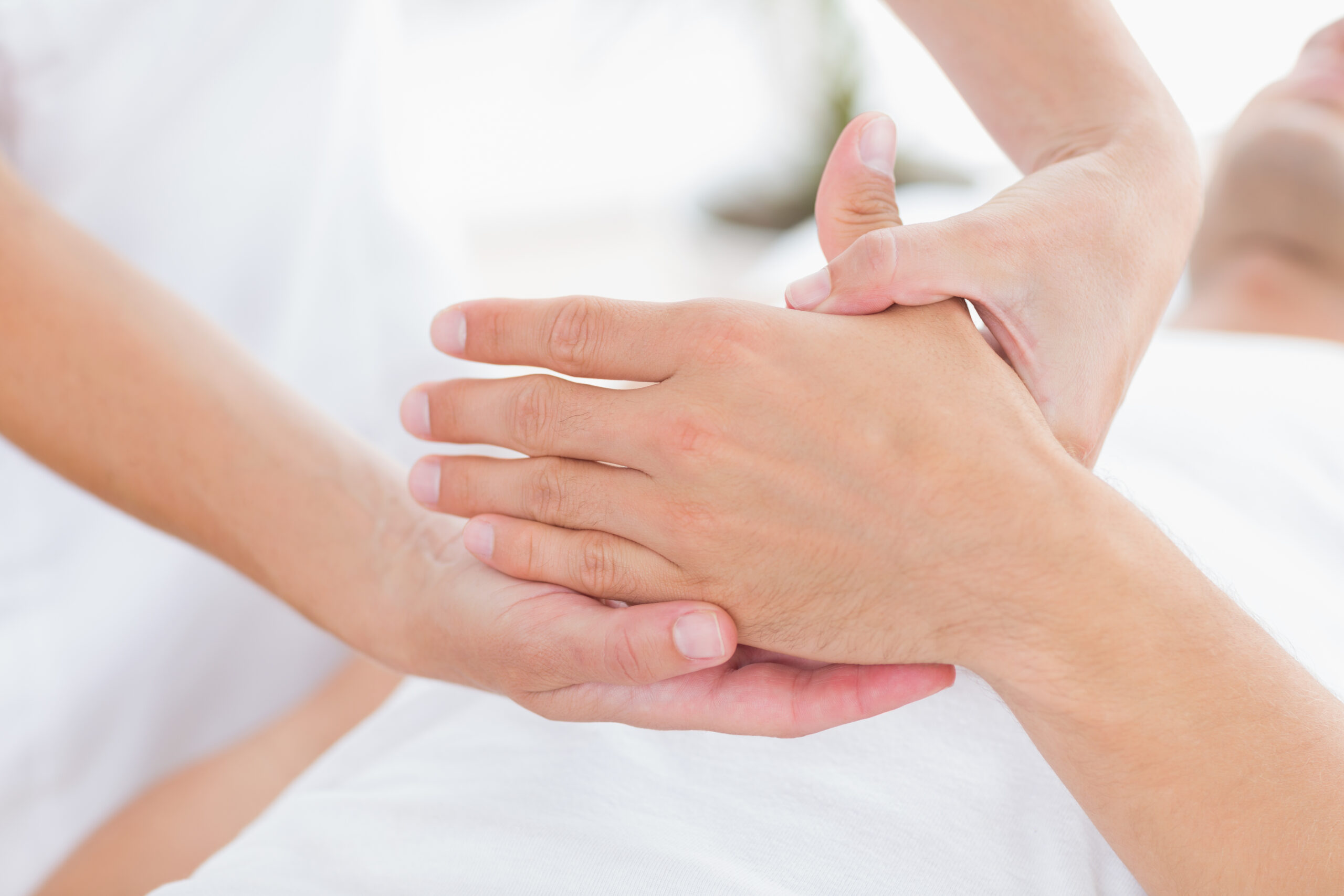 Physiotherapist doing hand massage in medical office