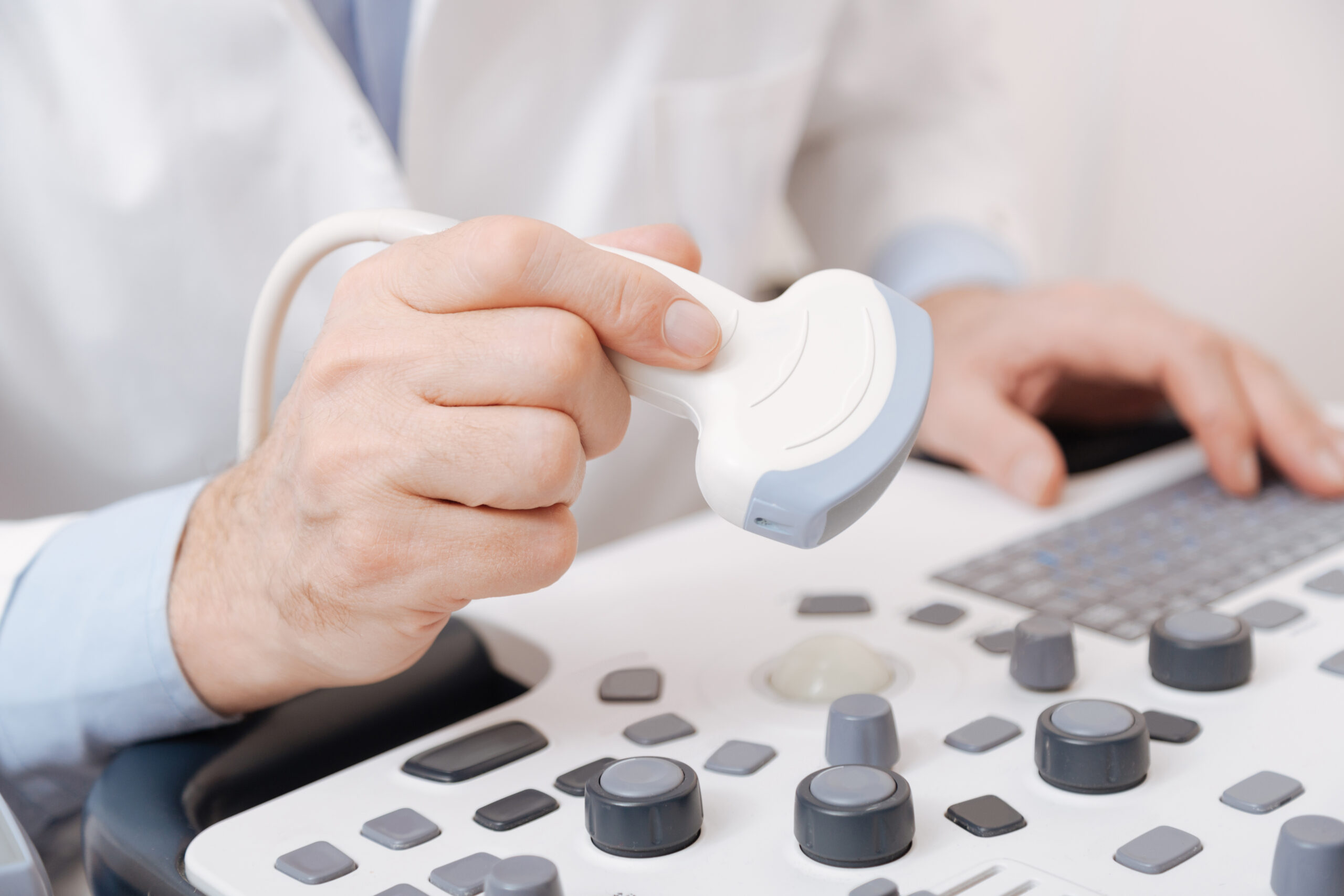 Diligent practitioner using sonogram equipment in the hospital